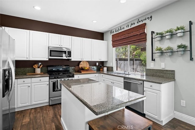 775 Via Blairo, Corona, CA 92879 - kitchen with appliances with stainless steel finishes, dark wood finished floors, recessed lighting, white cabinetry, and a kitchen island