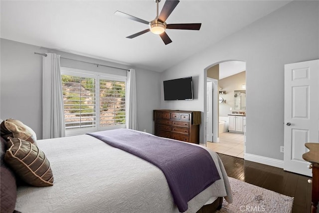 775 Via Blairo, Corona, CA 92879 - bedroom featuring lofted ceiling, arched walkways, wood finished floors, ceiling fan, and ensuite bath
