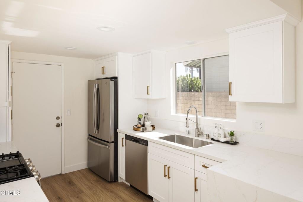 9465 E Camino Real Ave, Arcadia, CA 91007 - kitchen featuring appliances with stainless steel finishes, light wood-style floors, white cabinetry, recessed lighting, and light stone counters