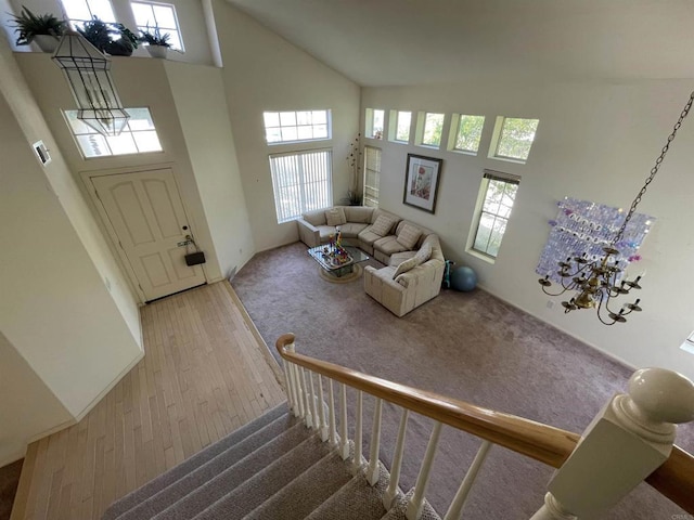 659 Rosita Ct, Chula Vista, CA 91910 - foyer with a high ceiling, a chandelier, plenty of natural light, stairway, and wood finished floors