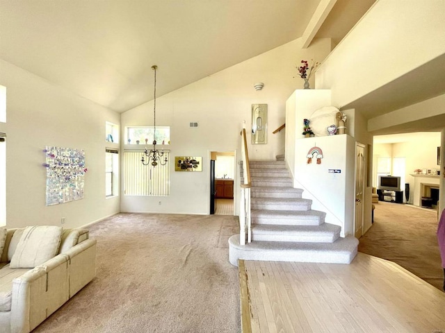 659 Rosita Ct, Chula Vista, CA 91910 - living room with high vaulted ceiling, a chandelier, carpet floors, and stairway