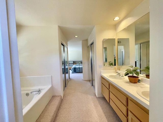 659 Rosita Ct, Chula Vista, CA 91910 - ensuite bathroom featuring double vanity, a garden tub, recessed lighting, and carpet