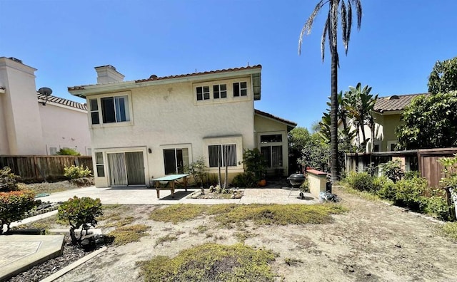659 Rosita Ct, Chula Vista, CA 91910 - back of house with a fenced backyard, a patio area, stucco siding, and a chimney