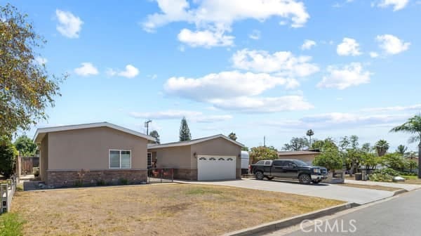 1724 S Vecino Ave, Glendora, CA 91740 - ranch-style house with stone siding, driveway, stucco siding, and an attached garage
