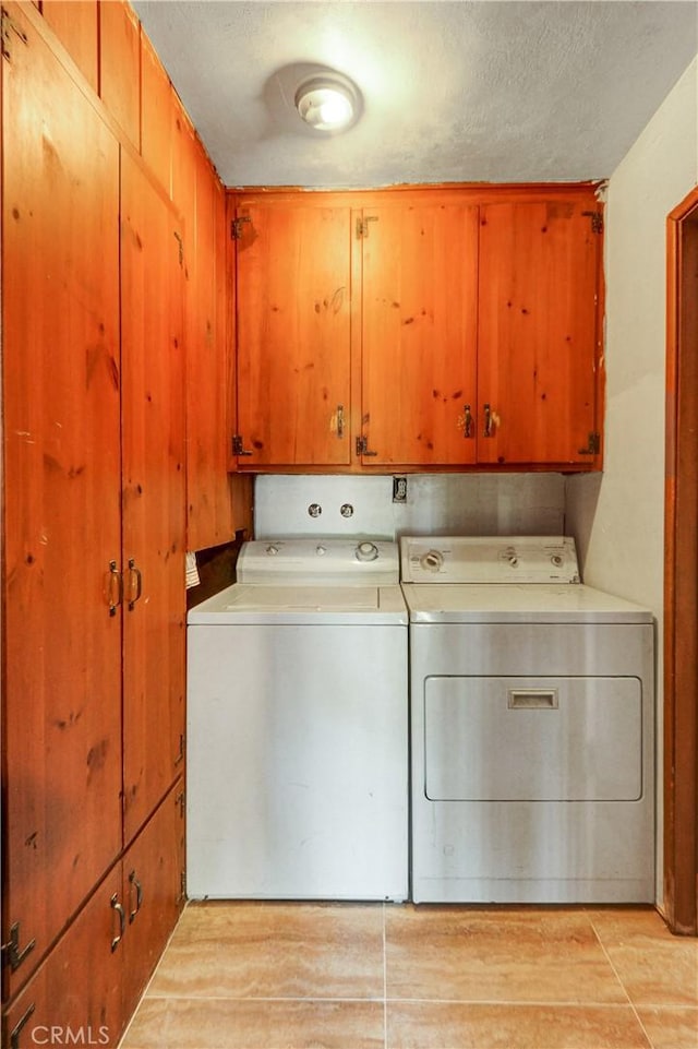 12108 Muriel Dr, Lynwood, CA 90262 - washroom featuring cabinet space, washer and dryer, a textured ceiling, and light wood-style floors
