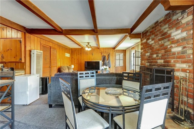12108 Muriel Dr, Lynwood, CA 90262 - dining space with beamed ceiling, wooden walls, a heating unit, a ceiling fan, and carpet