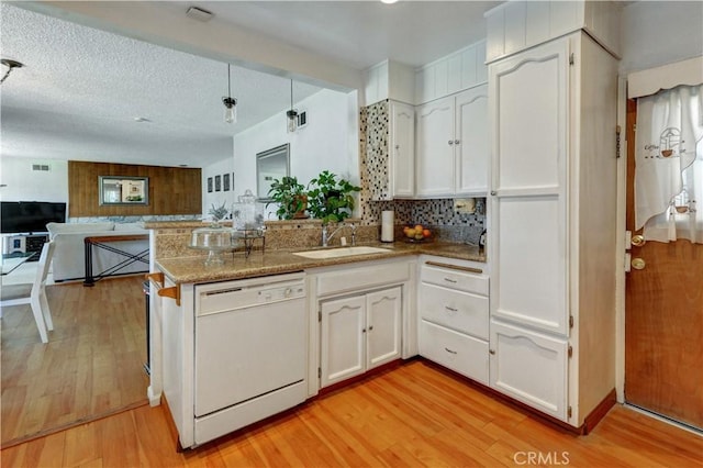 12108 Muriel Dr, Lynwood, CA 90262 - kitchen with dishwasher, a peninsula, light wood-style floors, and white cabinets