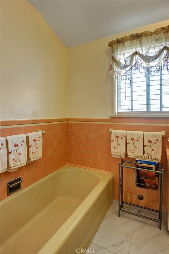 12108 Muriel Dr, Lynwood, CA 90262 - full bathroom featuring a garden tub, marble finish flooring, and a wainscoted wall