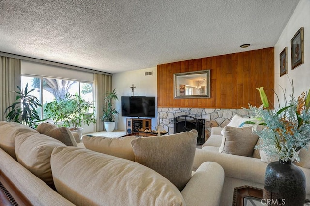 12108 Muriel Dr, Lynwood, CA 90262 - living area featuring a textured ceiling, a fireplace, and wooden walls