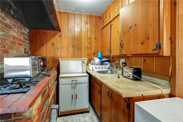 12108 Muriel Dr, Lynwood, CA 90262 - kitchen featuring light countertops, brown cabinets, and wood walls