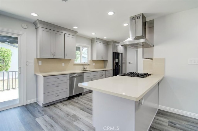 12517 Walcroft St, Lakewood, CA 90715 - kitchen with stainless steel dishwasher, range hood, black fridge, gray cabinetry, and recessed lighting