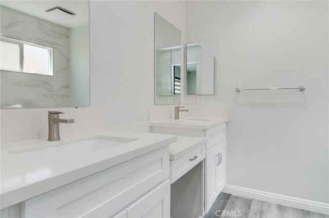 12517 Walcroft St, Lakewood, CA 90715 - bathroom featuring two vanities and wood finished floors