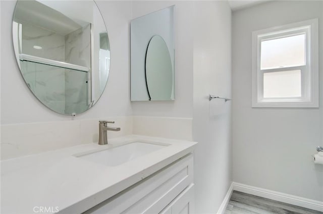 12517 Walcroft St, Lakewood, CA 90715 - bathroom featuring vanity, a marble finish shower, and wood finished floors