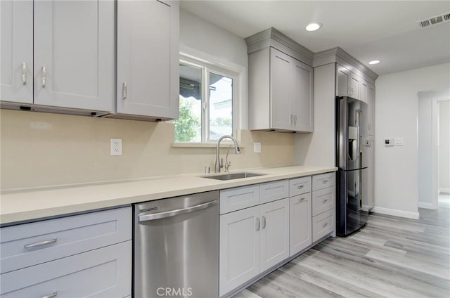 12517 Walcroft St, Lakewood, CA 90715 - kitchen featuring stainless steel appliances, light countertops, light wood-type flooring, recessed lighting, and gray cabinetry
