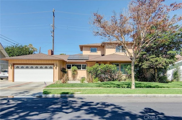 1251 Hackett Ave, Long Beach, CA 90815 - view of front of house featuring an attached garage, solar panels, concrete driveway, a chimney, and a front lawn