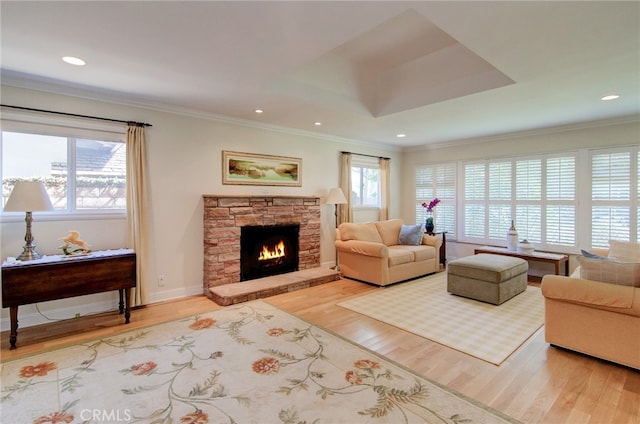1251 Hackett Ave, Long Beach, CA 90815 - living room with wood finished floors, a stone fireplace, crown molding, and recessed lighting