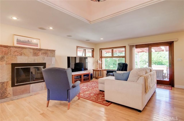 1251 Hackett Ave, Long Beach, CA 90815 - living area featuring light wood-type flooring, a tiled fireplace, and recessed lighting
