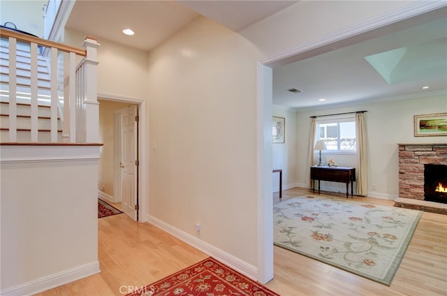1251 Hackett Ave, Long Beach, CA 90815 - corridor featuring light wood-type flooring, stairway, crown molding, and recessed lighting