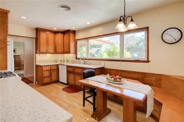 1251 Hackett Ave, Long Beach, CA 90815 - kitchen featuring white dishwasher, brown cabinetry, light wood-style floors, light countertops, and recessed lighting