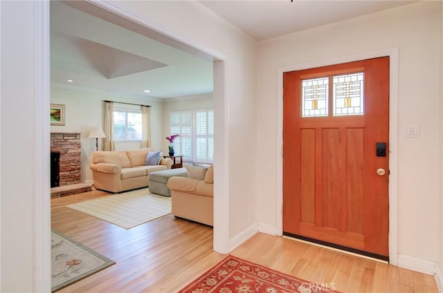1251 Hackett Ave, Long Beach, CA 90815 - foyer entrance with light wood-style floors, a fireplace, crown molding, and recessed lighting