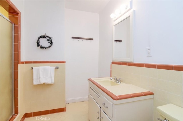 1251 Hackett Ave, Long Beach, CA 90815 - full bath featuring tile walls, a shower with shower door, vanity, and a wainscoted wall