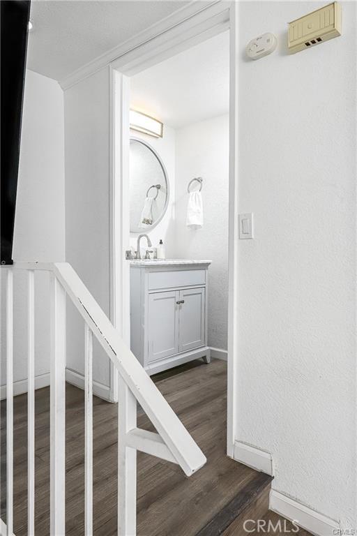 13750 Hubbard St Unit 77, Sylmar, CA 91342 - stairway featuring baseboards and wood finished floors