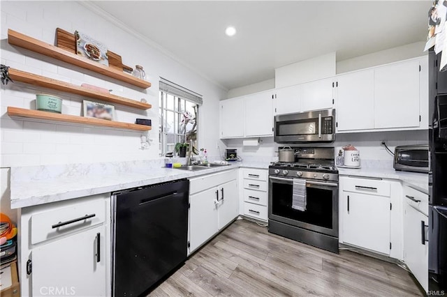 13750 Hubbard St Unit 77, Sylmar, CA 91342 - kitchen with appliances with stainless steel finishes, open shelves, white cabinetry, crown molding, and recessed lighting