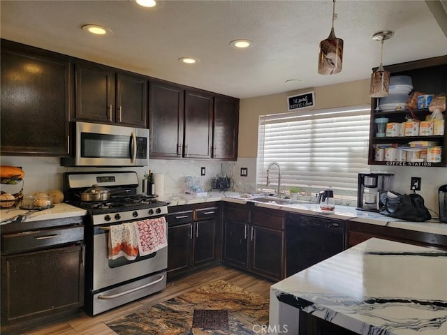 36901 33rd St E, Palmdale, CA 93550 - kitchen featuring appliances with stainless steel finishes, light wood-style floors, recessed lighting, light countertops, and hanging light fixtures