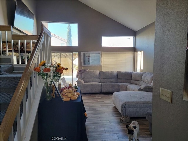 36901 33rd St E, Palmdale, CA 93550 - living area featuring high vaulted ceiling, wood finished floors, a textured wall, and stairway