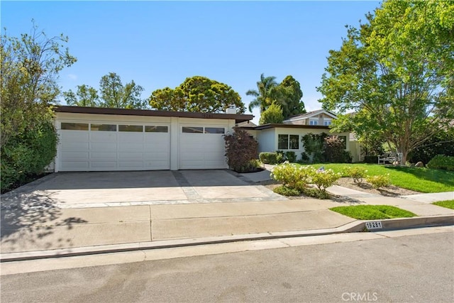 19281 Sierra Inez Rd, Irvine, CA 92603 - view of front facade featuring concrete driveway, a garage, a front yard, and stucco siding
