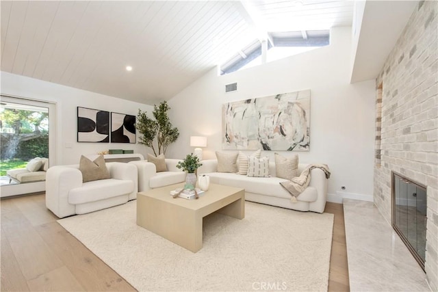 19281 Sierra Inez Rd, Irvine, CA 92603 - living room featuring light wood-style flooring, a brick fireplace, a skylight, and wood ceiling