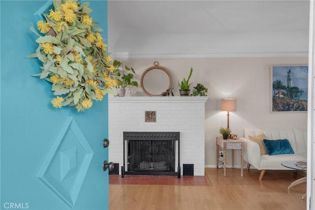 1269 W 1st St, San Pedro, CA 90732 - living area featuring a brick fireplace, wood finished floors, and ornamental molding