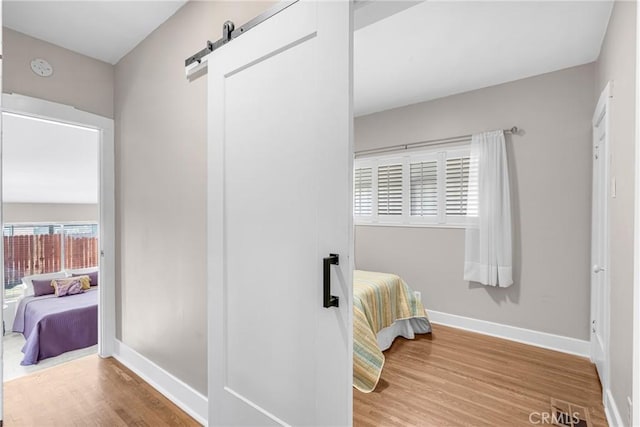 1269 W 1st St, San Pedro, CA 90732 - bedroom featuring a barn door and wood finished floors