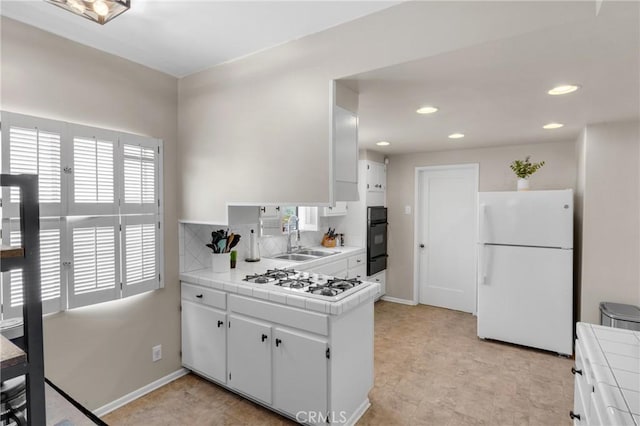 1269 W 1st St, San Pedro, CA 90732 - kitchen with white appliances, tile counters, a warming drawer, healthy amount of natural light, and recessed lighting