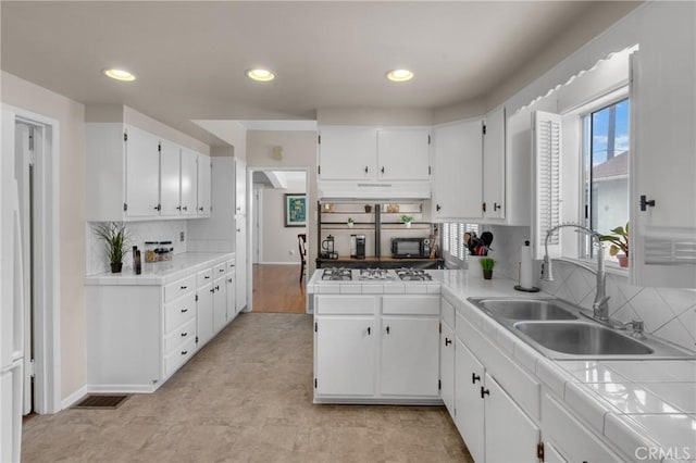 1269 W 1st St, San Pedro, CA 90732 - kitchen with white gas stovetop, white cabinetry, tile countertops, and recessed lighting