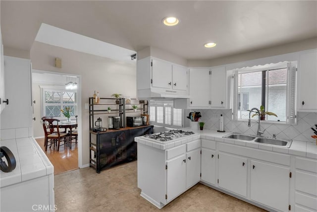 1269 W 1st St, San Pedro, CA 90732 - kitchen with tile countertops, white gas stovetop, decorative backsplash, white cabinetry, and recessed lighting