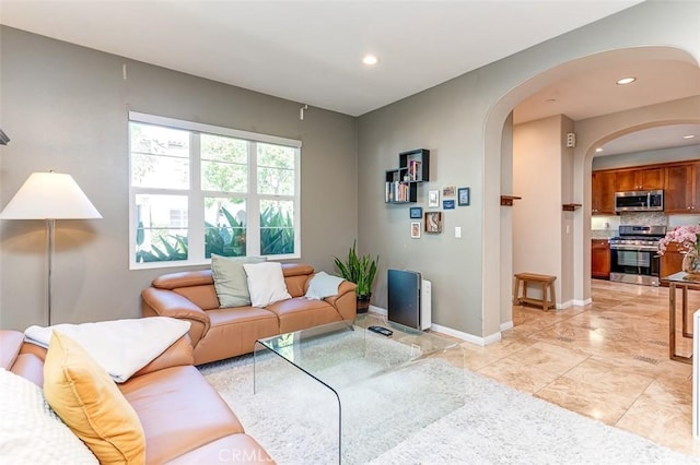 440 N Santa Maria St, Anaheim, CA 92801 - living room featuring arched walkways, recessed lighting, and light marble finish floors