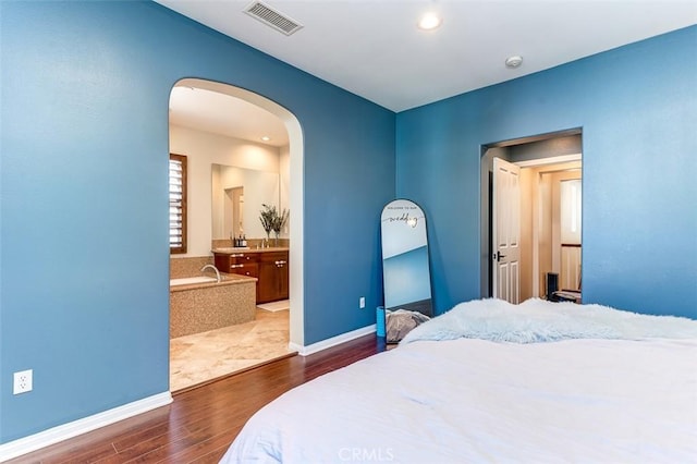 440 N Santa Maria St, Anaheim, CA 92801 - bedroom featuring arched walkways, dark wood-type flooring, recessed lighting, and ensuite bath