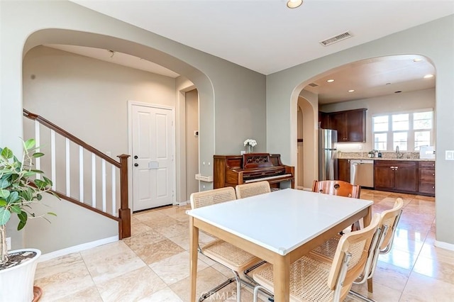 440 N Santa Maria St, Anaheim, CA 92801 - dining space featuring arched walkways, recessed lighting, and stairs
