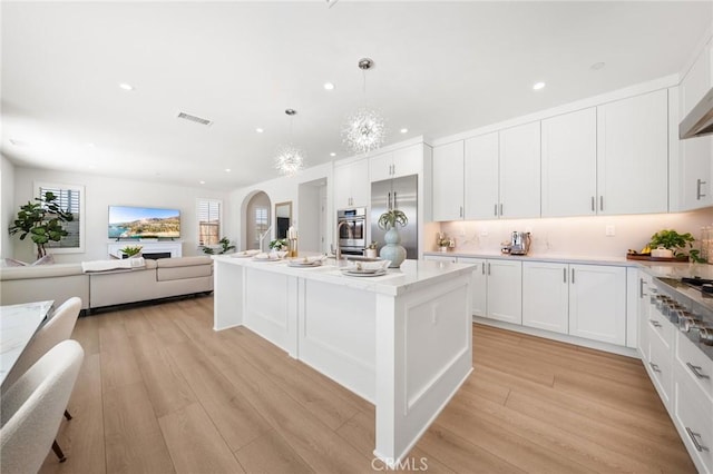 246 Canterbury, Irvine, CA 92618 - kitchen with stainless steel appliances, recessed lighting, light wood-style floors, white cabinets, and pendant lighting