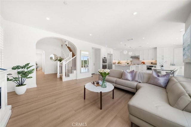 246 Canterbury, Irvine, CA 92618 - living room with arched walkways, stairway, light wood-style flooring, and recessed lighting