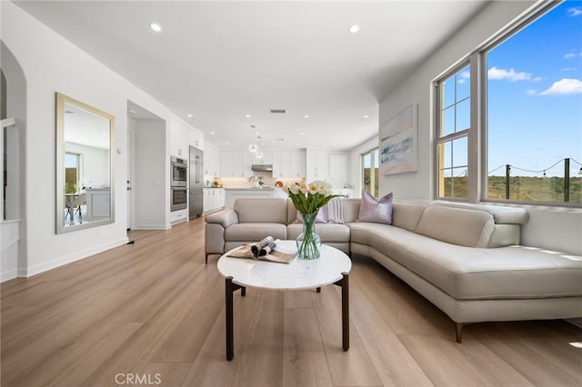 246 Canterbury, Irvine, CA 92618 - living area featuring plenty of natural light, light wood-style floors, recessed lighting, and arched walkways