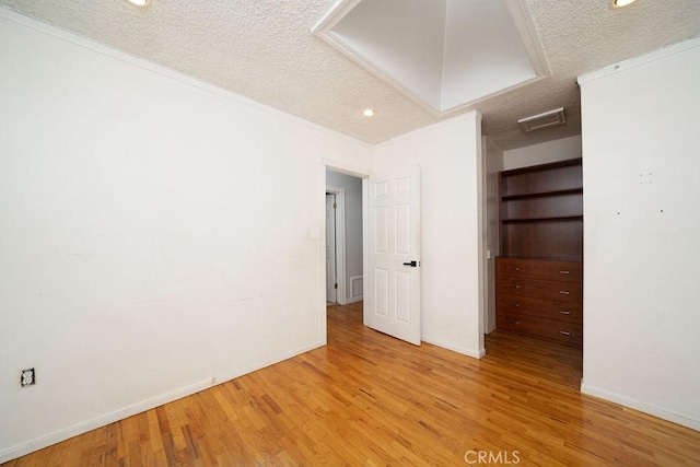 11302 Cheddar St, Norwalk, CA 90650 - unfurnished room with a textured ceiling, wood finished floors, crown molding, recessed lighting, and attic access