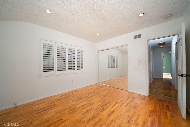 11302 Cheddar St, Norwalk, CA 90650 - unfurnished bedroom with light wood-style flooring, a textured ceiling, a closet, and recessed lighting