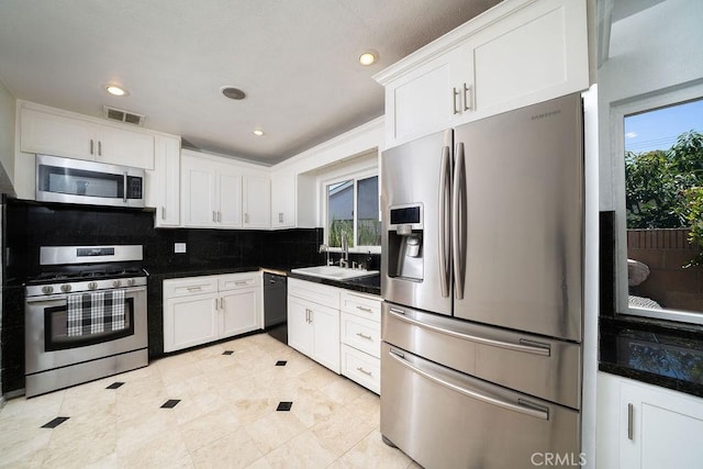 11302 Cheddar St, Norwalk, CA 90650 - kitchen featuring stainless steel appliances, backsplash, white cabinets, dark countertops, and recessed lighting