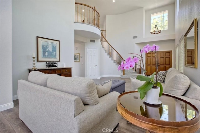 32197 Callesito Fadrique, Temecula, CA 92592 - living room with a towering ceiling, a chandelier, stairs, and wood finished floors