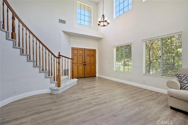 32197 Callesito Fadrique, Temecula, CA 92592 - entryway featuring a chandelier, wood finished floors, a towering ceiling, and stairway