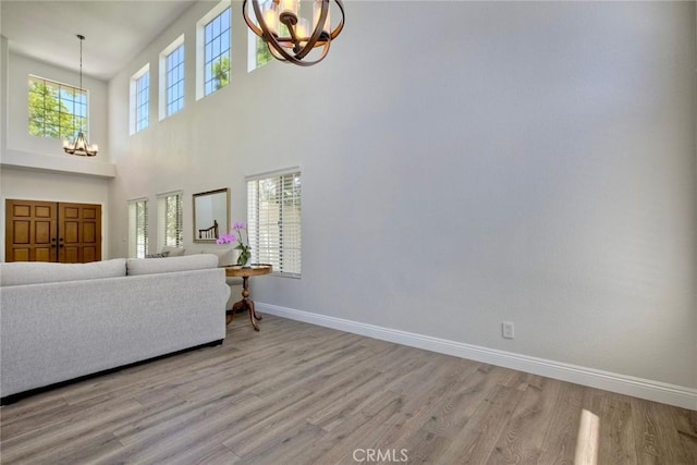 32197 Callesito Fadrique, Temecula, CA 92592 - living area featuring a chandelier, light wood-style floors, and a high ceiling