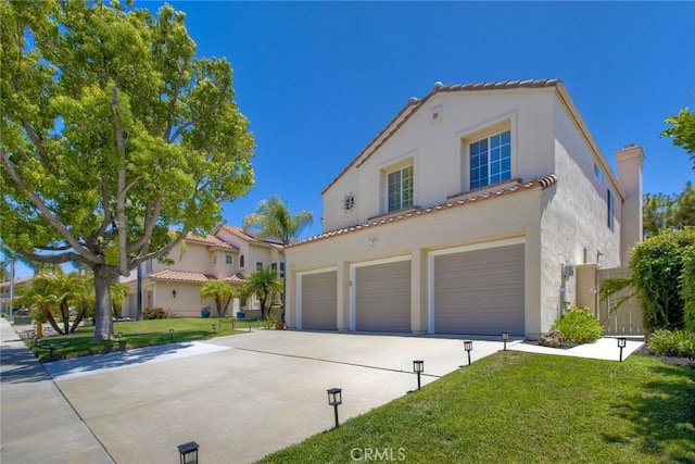 32197 Callesito Fadrique, Temecula, CA 92592 - mediterranean / spanish-style home with driveway, a garage, stucco siding, a front yard, and a tile roof
