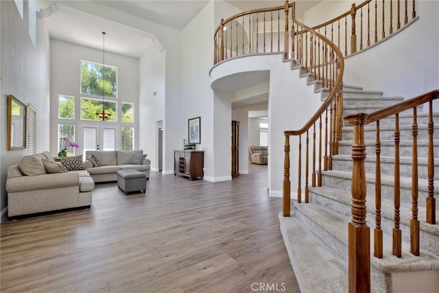 32197 Callesito Fadrique, Temecula, CA 92592 - living area featuring a towering ceiling, wood finished floors, and stairs